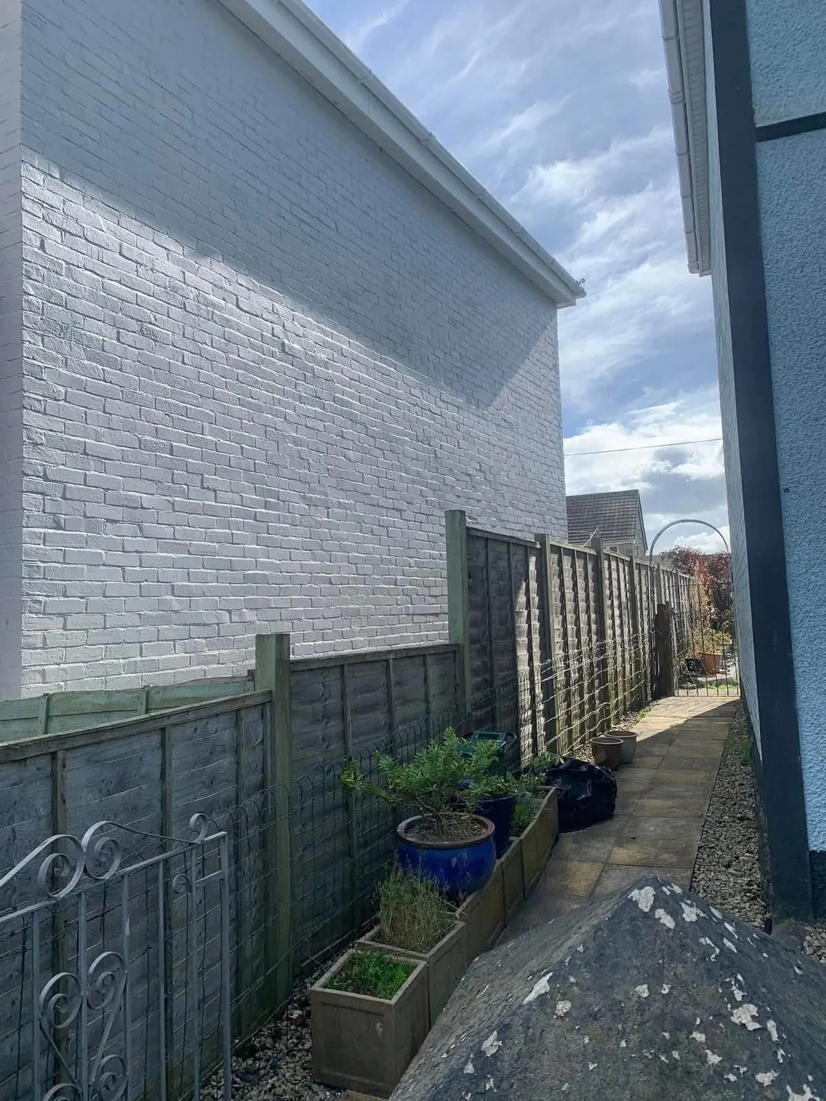 Freshly painted brick wall after preparation and masonry paint in Callington